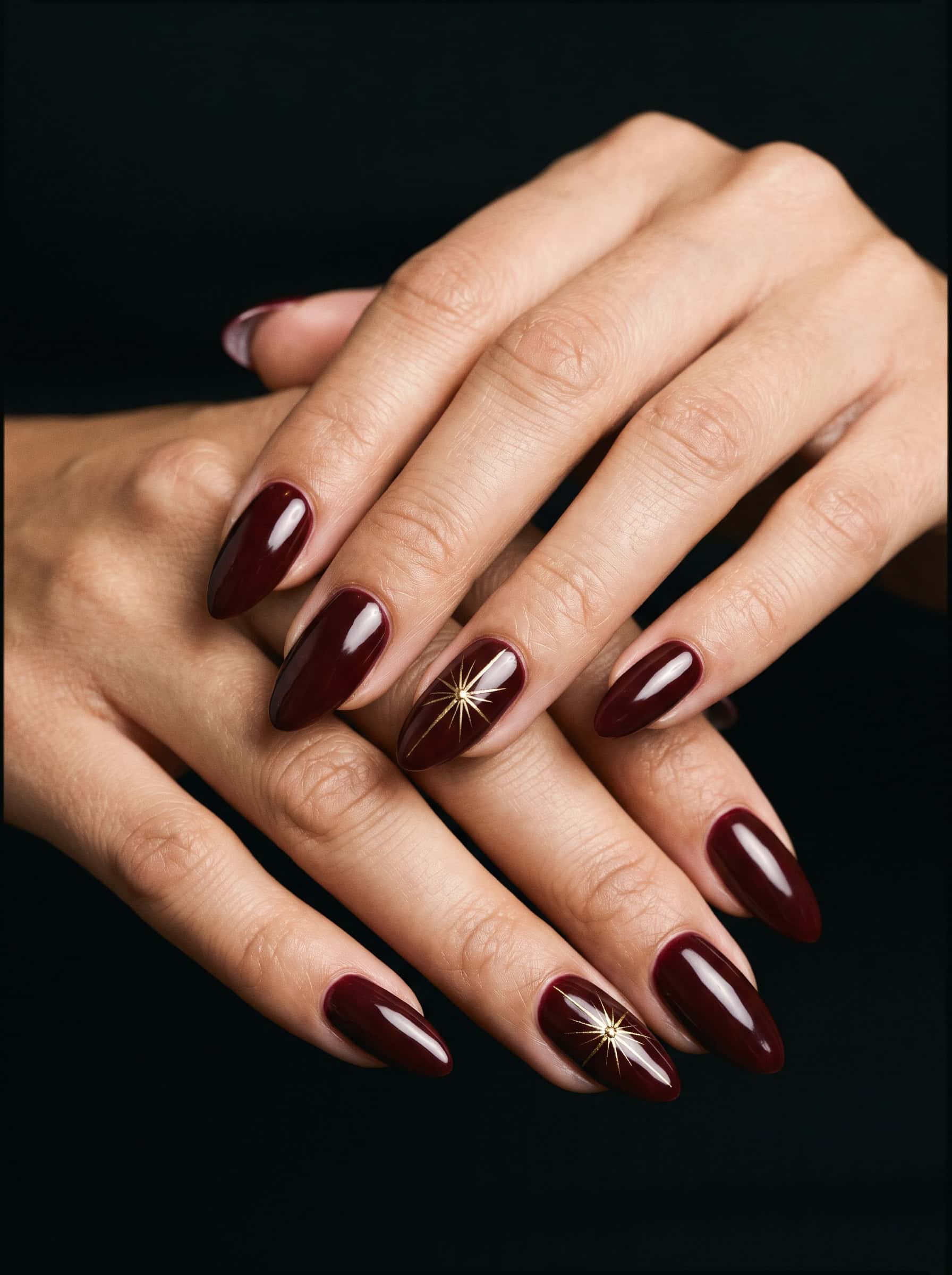Burgundy Nails With Gold Starbursts